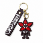 Stranger Things Demogorgon PVC keychain featuring a stylized Demogorgon character with a red flower-shaped head, matching Stranger Things silicone wrist strap, gold-tone keyring, and lobster clasp on a white background.