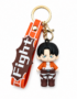 Attack on Titan Levi Ackerman chibi PVC keychain with a Scout Regiment silicone wrist strap, gold-tone keyring, lobster clasp, and detailed Survey Corps uniform on a white background.